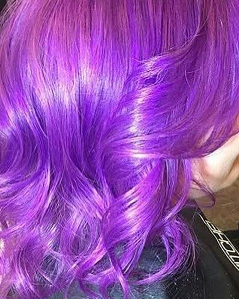 Bright purple color on shoulder-length waves