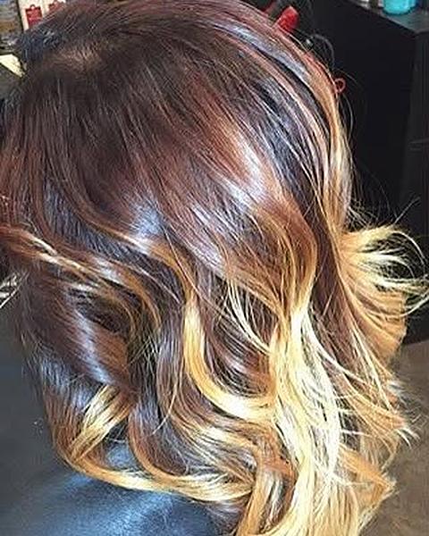 A brunette to blonde ombre with loose curls